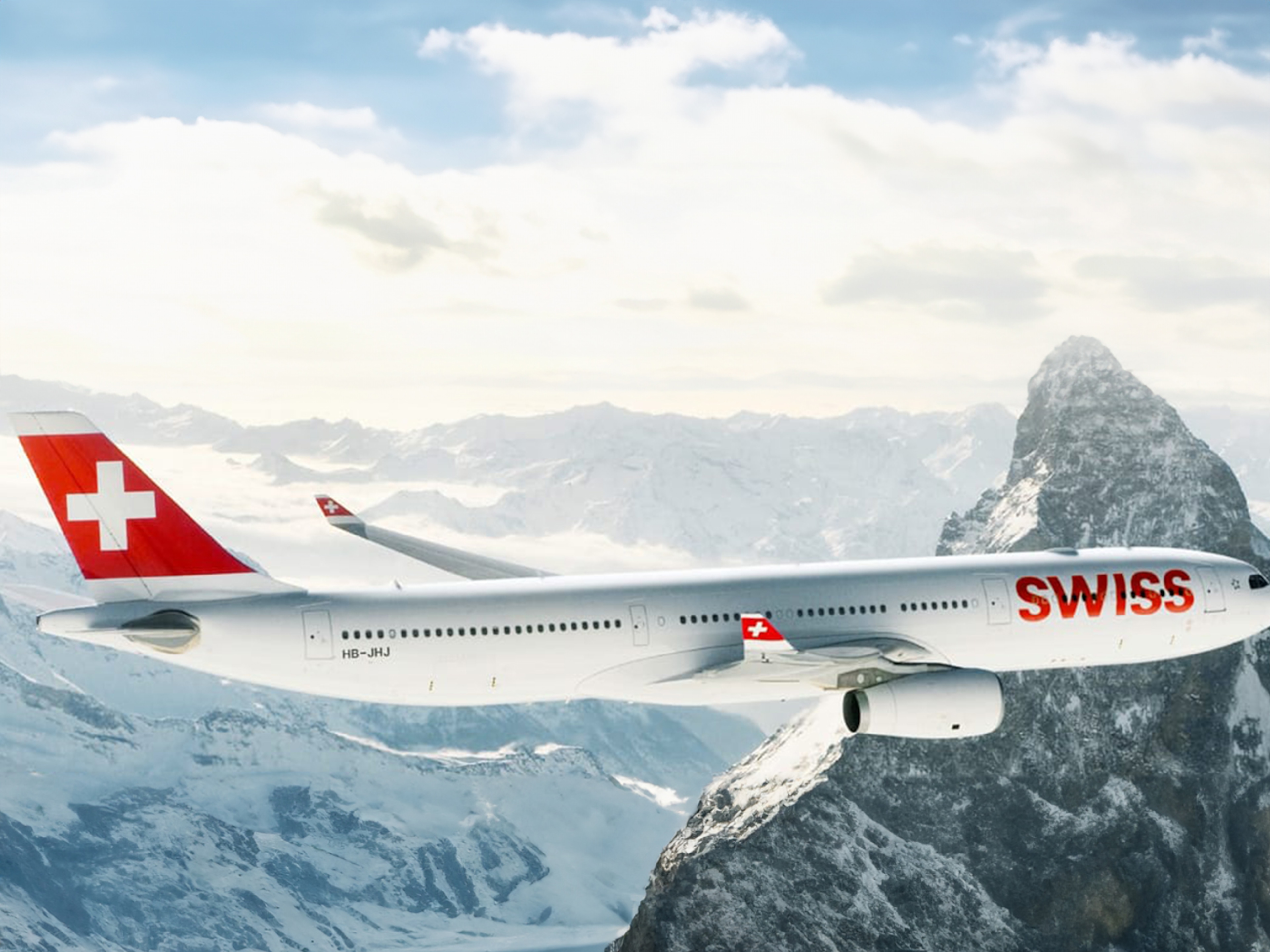 一架SWISS飛機飛越阿爾卑斯山，代表百年靈與SWISS國際航空公司的合作關係。